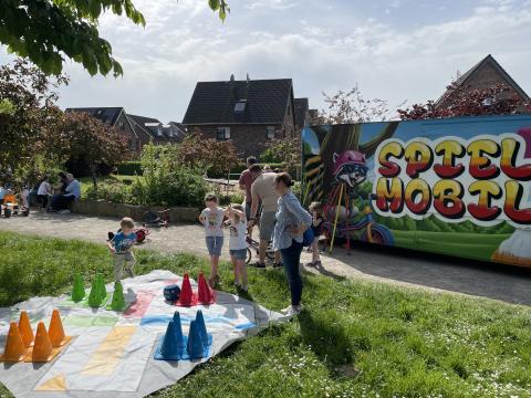 Das Spielmobil, mehrere Kinder und ein großes Menschärger dich nicht